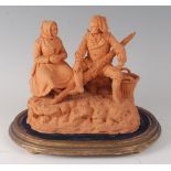 A 19th century terracotta figure group of a seated peasant couple, indistinctly signed, w.22.5cm