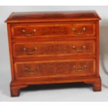 A figured walnut and inlaid three drawer chest, in the early 18th century style, having a four