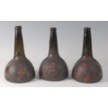 A set of three circa 1700 Dutch commemorative painted onion wine bottles, each with portrait