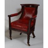 A Regency mahogany framed library chair, the whole with studded red leather upholstered padback