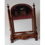 An early Victorian rosewood dressing table mirror, the arched plates supported on flaring