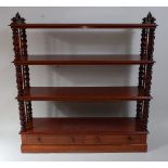 An early Victorian mahogany four-tier whatnot, having double spiral turned end columns, the base