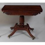A Regency mahogany and rosewood crossbanded pedestal tea table, the fold-over top with swivel