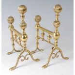 A pair of early 19th century brass andirons, each having reeded and knopped finials, h.28.5cm