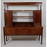 A late Georgian oak and mahogany crossbanded dresser, the upper section having three-tier plate rack