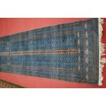 A Persian woollen blue ground hall runner, the field decorated with four panels of gull motifs