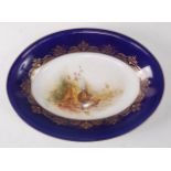 A Royal Worcester porcelain dish, the central ground painted with birds on a riverbank by W.H.