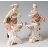 A pair of 19th century Berlin porcelain figures of grape-pickers, each decorated in bright enamels