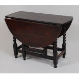 A circa 1700 joined oak gateleg table, having oval fall leaves and on bobbin turned and square cut