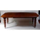 A Victorian oak extending dining table, the top having a moulded edge and two extra leaves, with