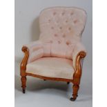 A Victorian mahogany framed spoonback armchair, the whole re-upholstered in a buttonback silk