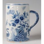 An 18th century English Delft tankard, underglaze blue decorated with symbols and birds amidst