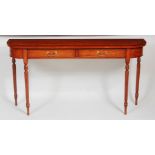 A satinwood and crossbanded two drawer hall table, raised on turned and reeded supports, w.155cm,