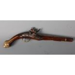 An 18th century Turkish flintlock pistol, having an engraved barrel and lock plates, with brass