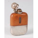 An early 20th century hip flask, having a leather covered glass body with silver plated mounts and