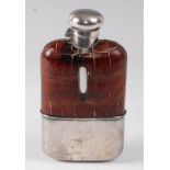 A Victorian hip flask, having a leather clad glass body with silver plated mounts and removeable