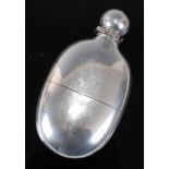 A fine quality Victorian silver hip flask of oval form, the bayonet cap revealing a gilt interior,