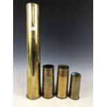 A post war 76mm shell case together with three other post war shell cases