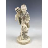 A Japanese bone okimono of a figure with a gourd, 21 cm