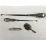 Items of antique silver, including two Edwardian silver handled button hooks, a folding silver fruit