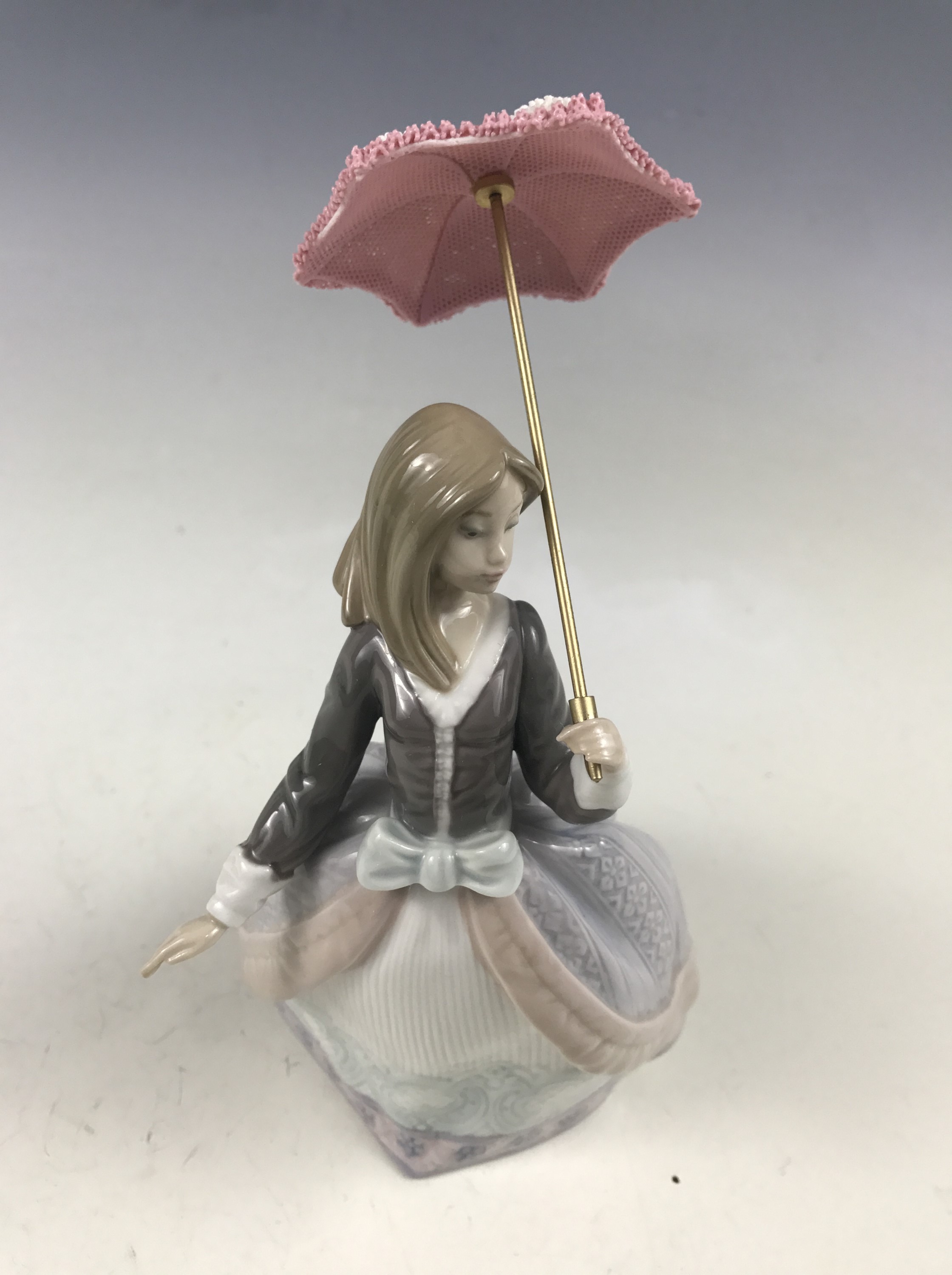A Lladro figurine Angela 5211, girl with parasol, retired