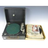 A portable gramophone with records