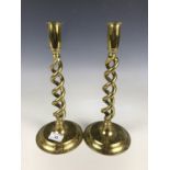 A pair of brass helical candlesticks