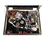 A quantity of vintage costume jewellery including necklaces and brooches in a velvet lined wooden