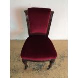 A Victorian red dralon upholstered nursing chair with brass castors