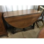 An oak drop leaf table with gate leg