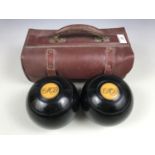 A cased pair of bowling woods