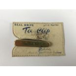 A 1950s "Real Knife Gold Plated Tie Clip" by Richards of Sheffield, with original packaging