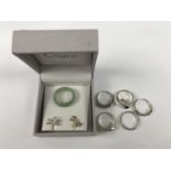 A number of contemporary white metal (tested as silver) dress rings, a jade ring and a pair of