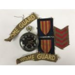 A Second World War army pocket watch together with Home Guard cloth insignia