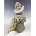 A Lladro Little Jester sitting clown figurine, 5203