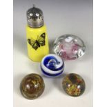 Three glass paperweights together with a mushroom form-paperweight and a yellow glass sugar castor