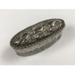 A small silver-lidded pin dish