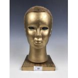 A gilt mannequin head