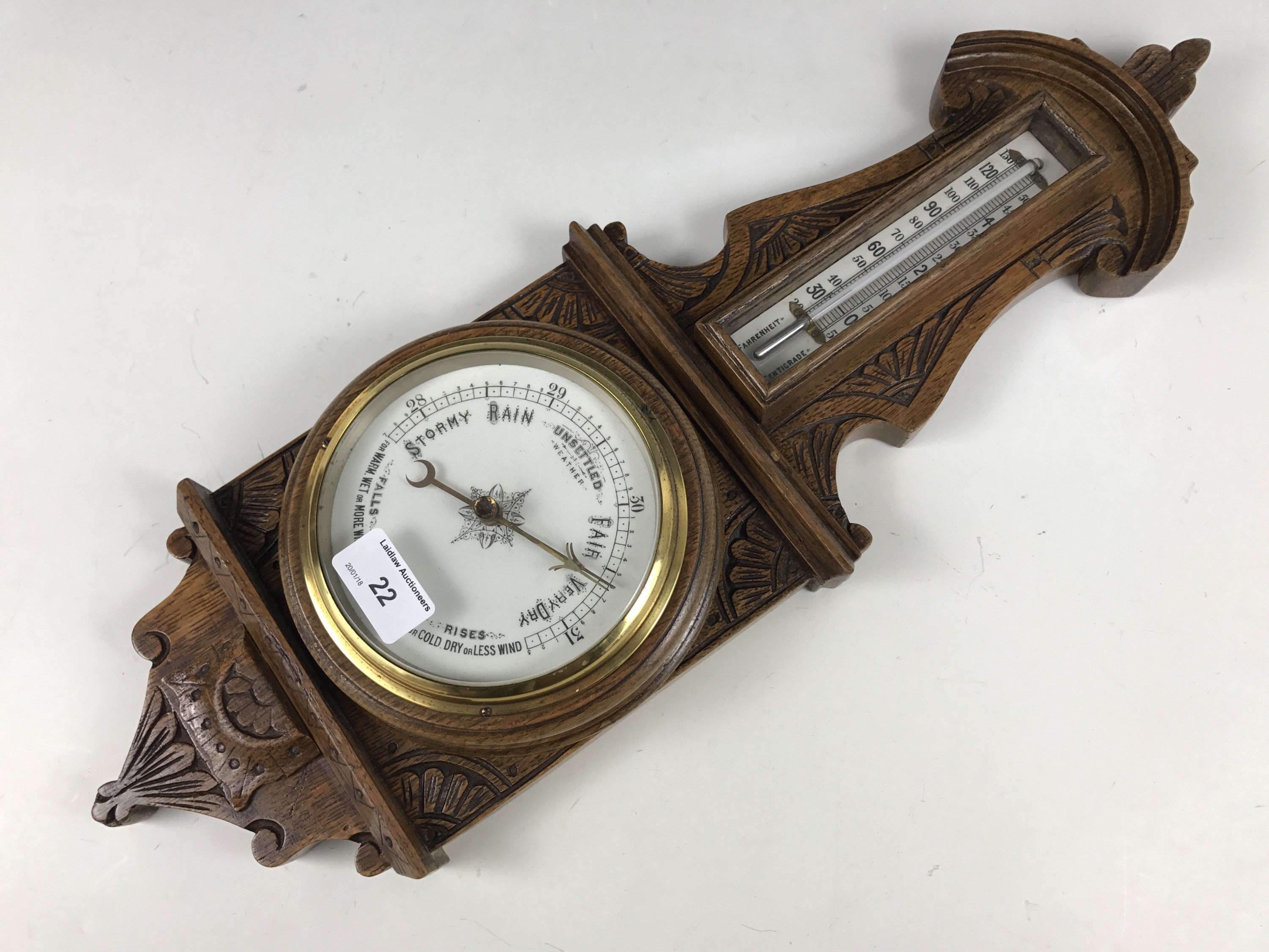 A Victorian carved oak banjo barometer