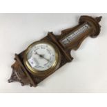 A Victorian carved oak banjo barometer