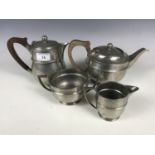 A four piece planished pewter tea set