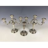 A pair of electroplate candelabra together with a matching candlestick