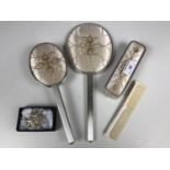 A vintage four piece dressing table set with embroidered detailing, together with a filigree