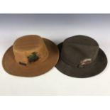 An American Fedora style large felt hat together with a waxed Australian bushman style large hat