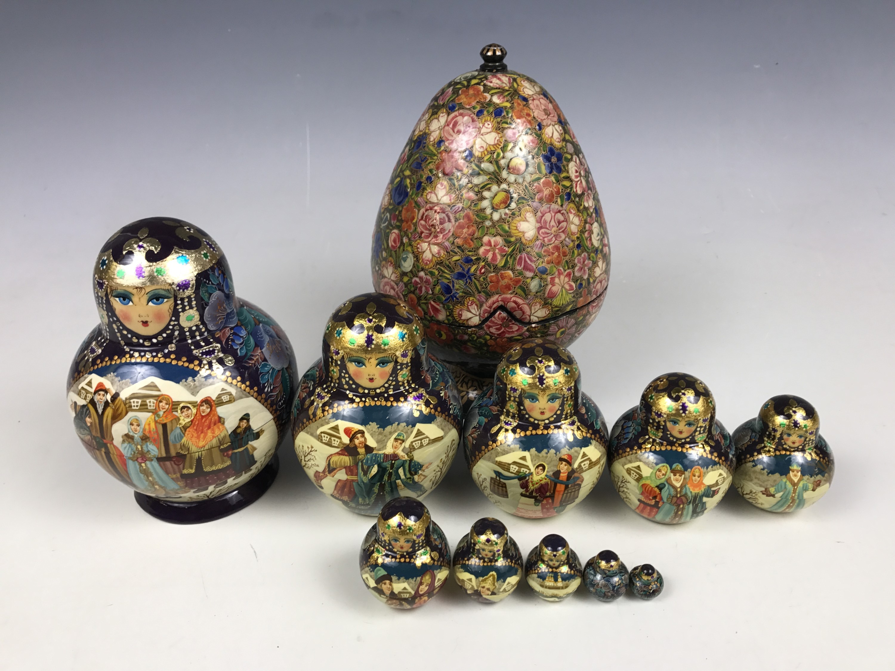 A set of Russian Maruska dolls together with an egg-form lacquered box