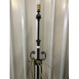 A black wrought iron extendable standard lamp