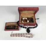 A red leather jewellery box together with sundry costume necklaces etc