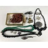 Period jewellery including a Victorian white metal brooch, an early 20th Century French jet