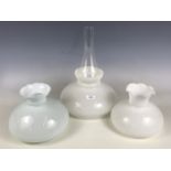 Three glass oil lamp shades together with a funnel