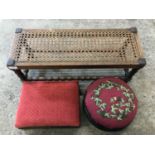 A cane-strung oak stool together with an embroidered ebonised pad stool and one other